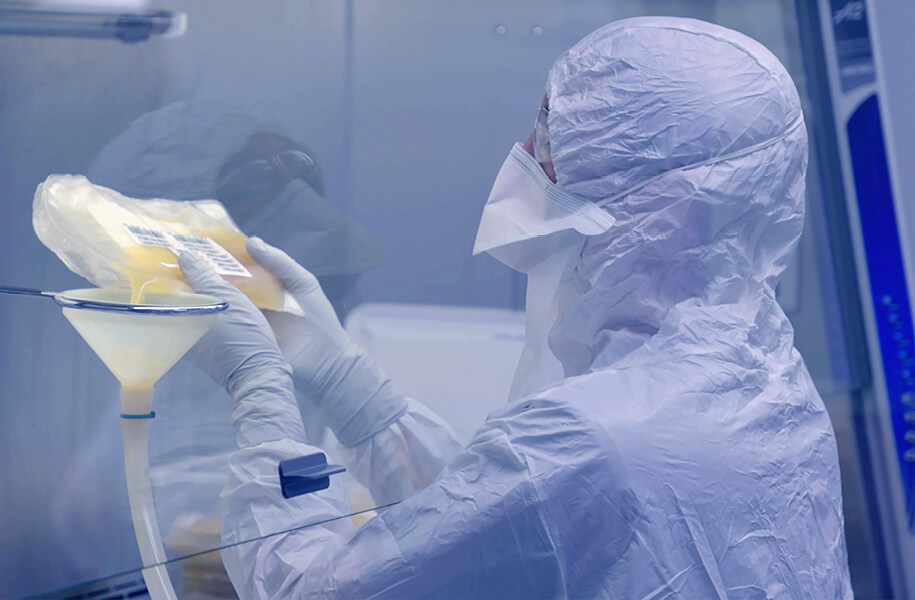 scientist in a lab wearing white hazmat suit pouring material into a funnel scientist in a lab wearing white hazmat suit pouring material into a funnel